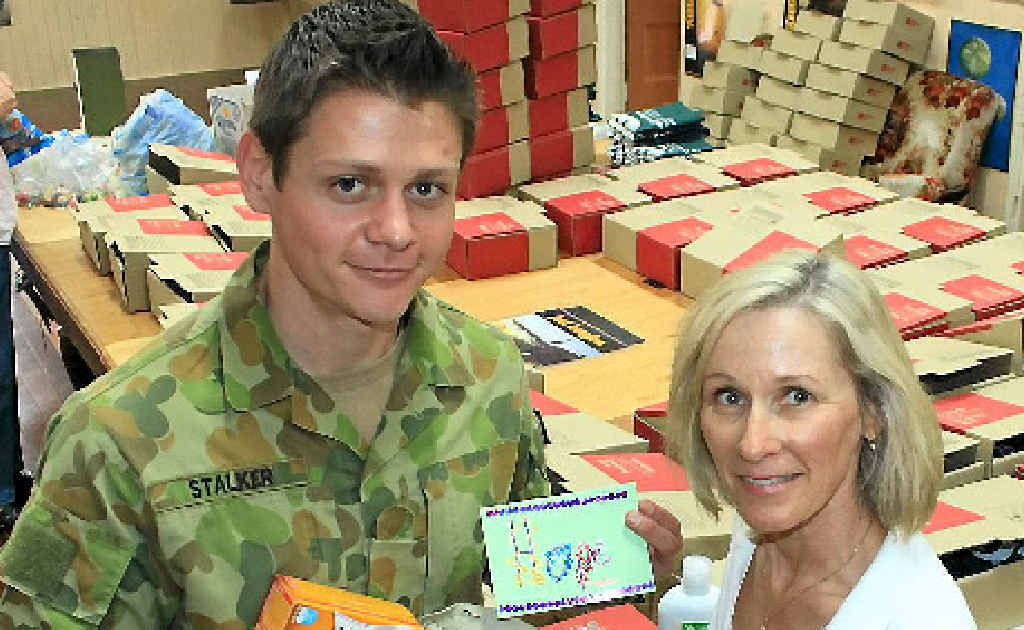 Private Robert Stalker and Penny Frederiksen pack hundreds of care boxes to send over to Aussie troops in Afghanistan. 